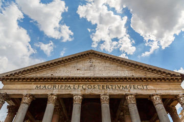 Italy Europe ancient roman pantheon temple front view at classical columns portico colonnade with surrounding historic rome buildings 