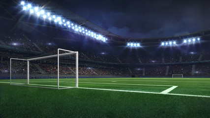 modern football stadium illuminated by spotlights and empty green grass