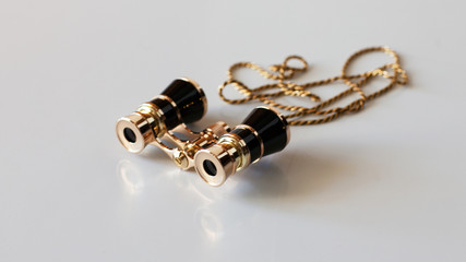Theatre binoculars on a gold chain