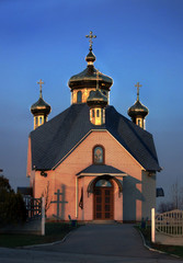 Fototapeta na wymiar Ukraine, village Dolinskoe, Zaporozhye, April 2, 2017 -new church in the classic style in rays of sunset