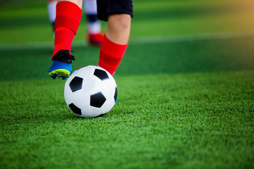 young boy soccer players run to trap and control the ball for shoot to goal