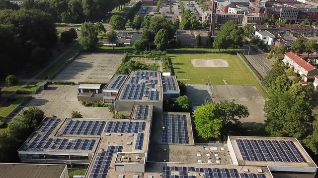 Drone view of a school covered in solar panels in Dronten, Flevoland, The Netherlands.