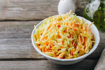 Coleslaw salad with white cabbage, carrots and mayonnaise dressing - obrazy, fototapety, plakaty