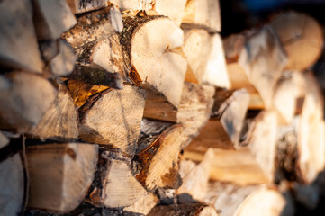 Stack of wirewood lit by sunlight. Close up photo