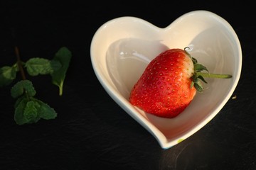 fresh red strawberry on black