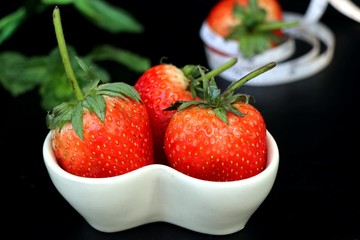 fresh red strawberry on black