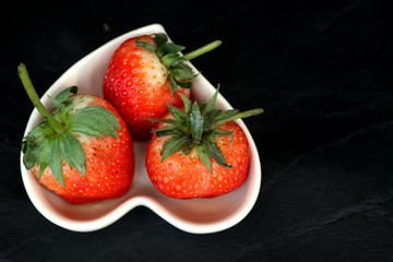 fresh red strawberry on black