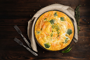 Home cooked frittata on a wooden table. Top view.