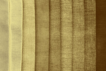 Luxury gold textile background. Silk cloth texture. Fabric pattern.