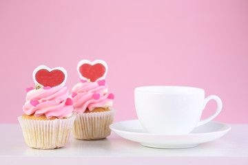 Cup of tea and cupcakes  on pink