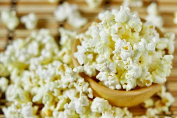 Close up, Butter popcorn in the wooden bowl and around