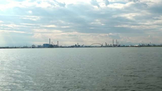 Slow zoom in, shot from a boat, of the industry on the banks of the Venetian Logion, Venice, Italy