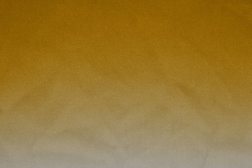 Luxury gold textile background. Silk cloth texture. Fabric pattern.