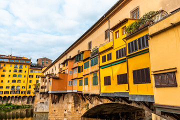 Fototapeta na wymiar Florence, Italy Firenze orange yellow colorful building closeup on Ponte Vecchio by Arno river during summer morning in Tuscany with nobody vibrant