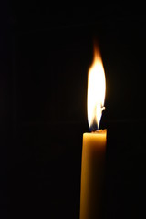 Candle flame illuminate in the dark.