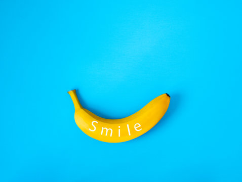 Ripe banana on blue background, flatlay, copy space