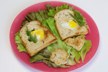 Breakfast of sausages, quail eggs, herbs and vegetables.