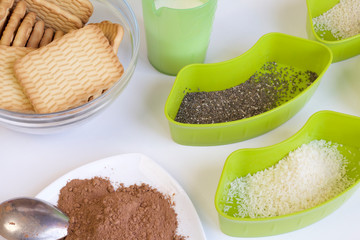 Ingredients placed on the table. Butter, biscuit crumb, cocoa and more. For making sweets