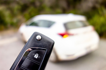 Black key fob for opening a white modern car