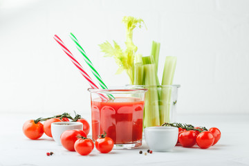 Glass of tomato juice and celery stems