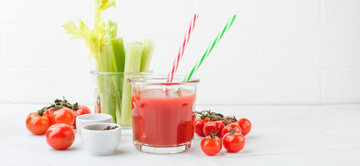 Glass of tomato juice and celery stems