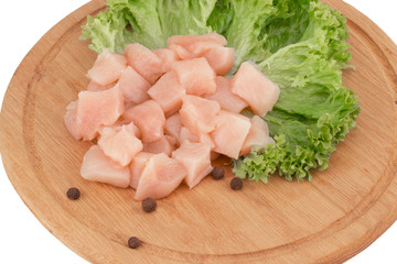 Raw chicken breast fillets on wooden cutting board