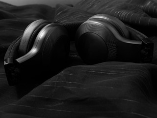 wireless black headphones on a dark background.