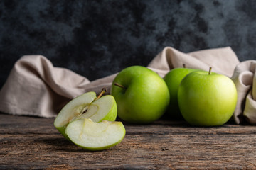 Green apples on wooden background.