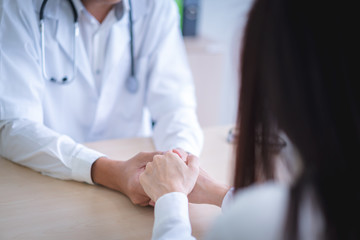 Doctor holds hands for patients to encourage.