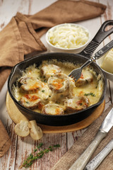 Mushrooms baked with cheese in a pan. National Georgian dish.