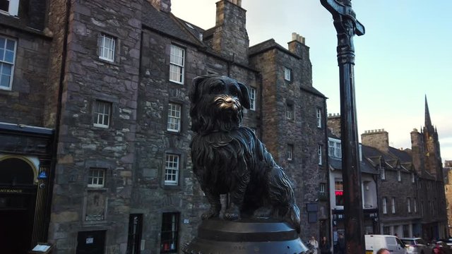 A woman's finger enters frame to touch the nose of the famous Greyfriar's Bobby statue on Candlemaker Row, Edinburgh, Lothian, UK