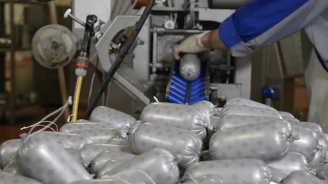 Meat-processing plant. Sausage industry. Final proccess in sausage production. Sausage production line in modern meat factory. Halal Certificate. Food industry. 4k