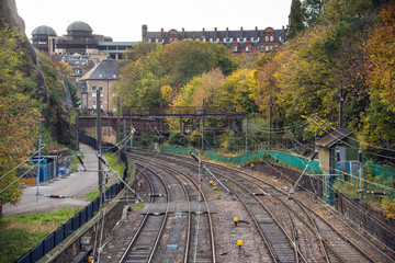 Railway Tracks Near a Train Station on a Fall Day