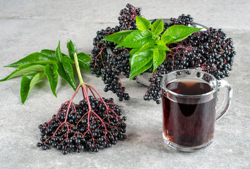 Clusters of elderberry and a glass of drink