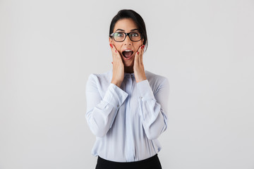 Photo of adult businesswoman wearing eyeglasses screaming in the office, isolated over white background