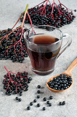 Ripe elderberry and drink in a glass