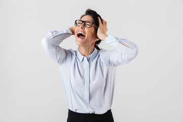Image of happy secretary woman wearing eyeglasses screaming in the office, isolated over white background