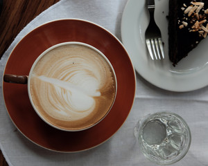 cup of hot coffee on table closeup with latte art pattern