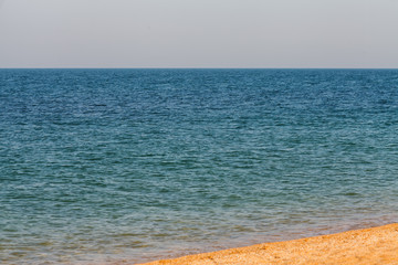 Blue sea background. Great blue sea. Texture. A piece of beach