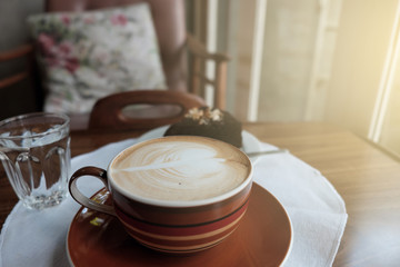 cup of hot coffee on table closeup with latte art pattern