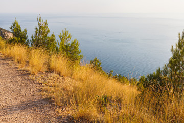 Serpentine road on the peninsula against the blue sea