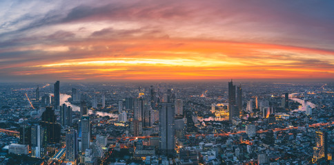 Panorama of Bangkok city river curved skyline with sunset light.