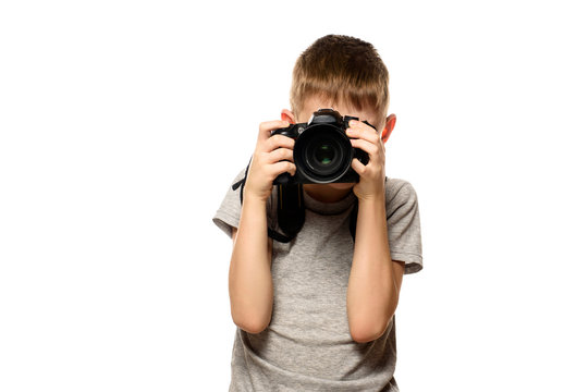 Boy takes pictures on the camera. Portrait. Isolate on white background