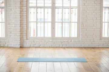 Yoga mat in empty fitness studio