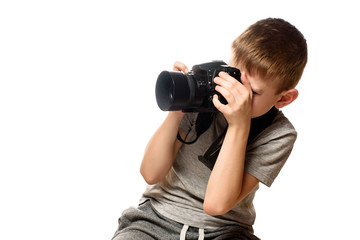 Boy takes pictures on the camera. Portrait. Isolate on white background
