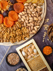 Vegan protein source. Beans, lentils, nuts and seeds. Top view on wooden table. Healthy vegetarian food.