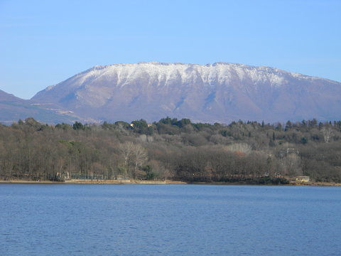 View of snowcapped Dajti mountain with Tirana's main park and artificial lake in the foreground, Albania