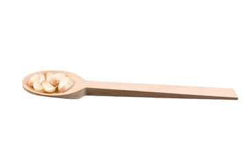 garlic cloves on wooden spoon isolated on white background