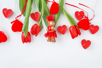 Beautiful Valentine's day background: bunch of red tulips, hearts decorations on white background with copy space