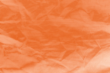 Fototapeta premium Elegant orange textile background. Silk cloth texture. Fabric pattern.